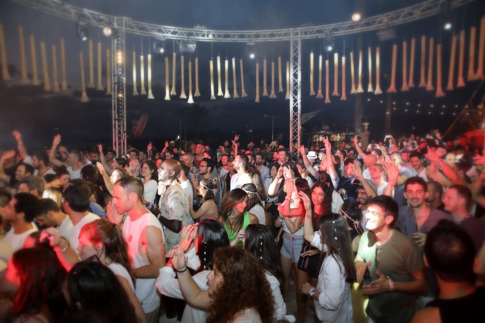 Crowd cheering under blue stage lights